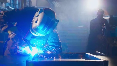 Two handymen welding and grinding metal at workshop Stock Footage 148512700
