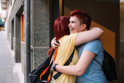 Two happy and very content big friends hugging each other, meeting again after a Stock Photos