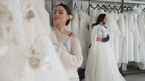 Two happy brides choose their wedding dress in the wedding salon. Stock Footage 322215625