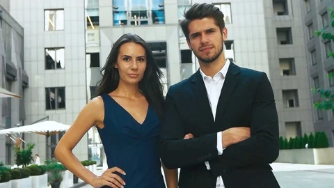 Two happy business partners posing in front of big business center Stock Footage 73813559