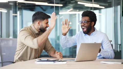 Two happy businessmen celebrating successful results using laptop computer  Stock Footage 329052447