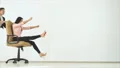 The two happy businesswomen playing with a chair. slow motion 4k or 4k+ Resolution