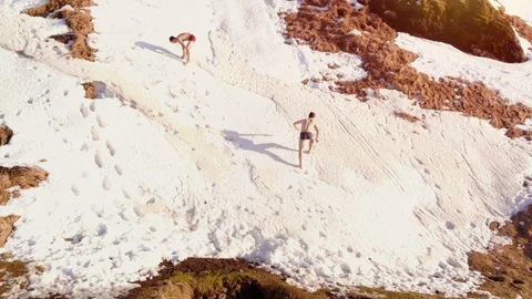 Two Happy casual man reckless act, he jumps upwards on the snow in Iceland Stock Footage 106400863