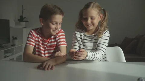 Two happy children playing dices at home Video stock 117627701