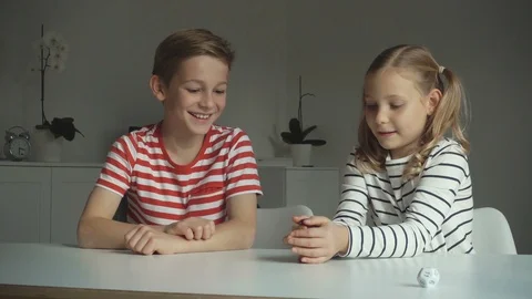Two happy children playing dices at home Video stock 117628115