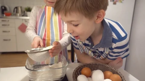 Two happy children playing during baking Easter sweets Stock Footage 72206718