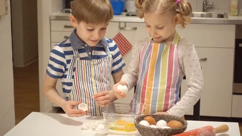 Two happy children playing during baking Easter sweets Stock Footage 72210024