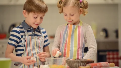 Two happy children playing during baking Easter sweets Stock Footage 72211029