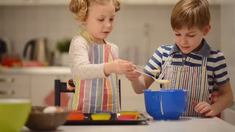 Two happy children playing during baking Easter sweets Video stock 72211780