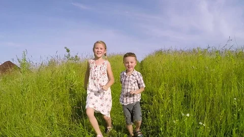 Two happy children playing on the road at the day time. Stock Footage 71636040