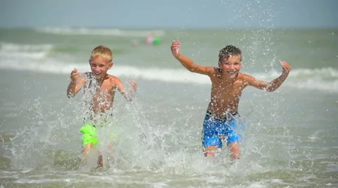 Two happy  children splash and play in the sea. Stock Footage 42190145