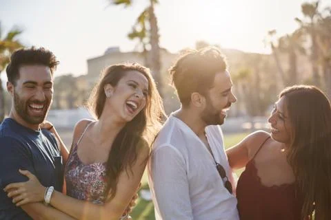 Two happy couples having fun outside laughing Stock Photos