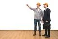 The two happy engineers gesture on the white wall background Photo