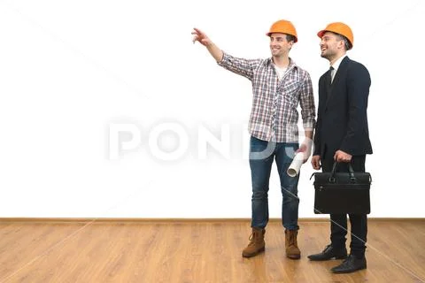 The two happy engineers gesture on the white wall background Stock Photos
