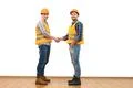 The two happy engineers handshake on the white wall background Photo