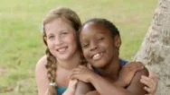 Two Happy Female Friends Hugging And Looking At Camera Stock Footage