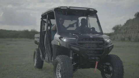 Two Happy Friends Drive Off Camera in their Off-road Utility Vehicle Stock Footage 323404107