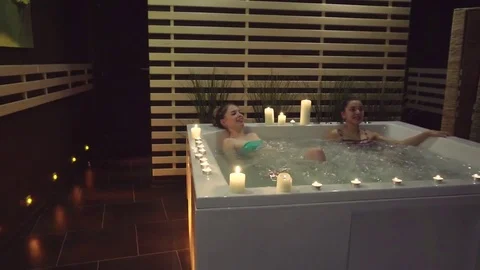 Two happy friends rest in the jacuzzi, saturated with sea salt in the spa center Stock-Footage 73641580