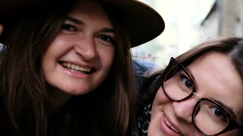 Two happy girlfriends having fun in front of photo camera Stock Footage 85906776