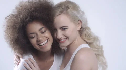 Two happy girlfriends posing on white background. Stock Footage 58903955