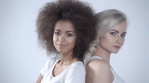 Two happy girlfriends posing on white background Stock Footage 58904723