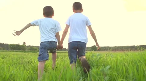 Two happy kids running on summer green field Stock Footage 59081391