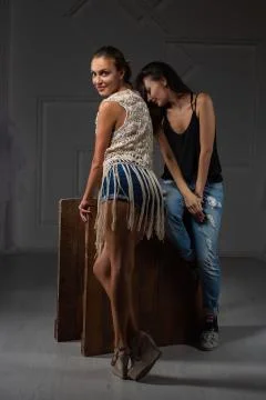 Two happy lady posing in a studio. Stock Photos