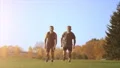 The two happy men running in the park. slow motion 4k or 4k+ Resolution