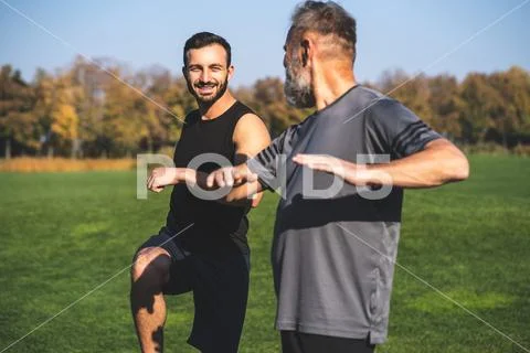 The two happy men stretching outdoor Stock Photos