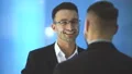The two happy men talk on the blue background. slow motion 4k or 4k+ Resolution