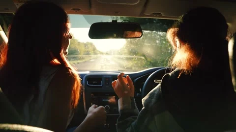 Two happy redhead young female friends dancing having fun driving car road trip Stock Footage 268748907