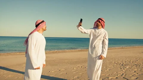 Two Happy Sheiks Friends Taking Pictures At The Sea Stock Footage 301935754