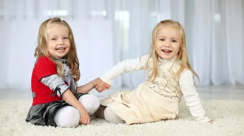 Two happy  sisters looking at camera holding hands. DOLLY HD 動画素材 8956856