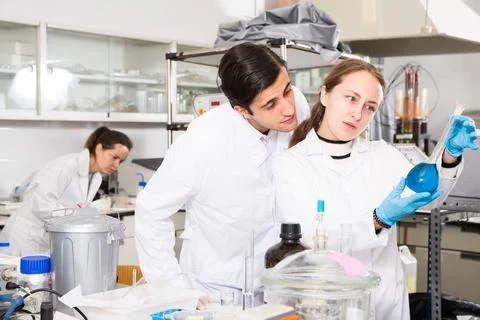 Two happy technicians discussing while working Stockfoto's