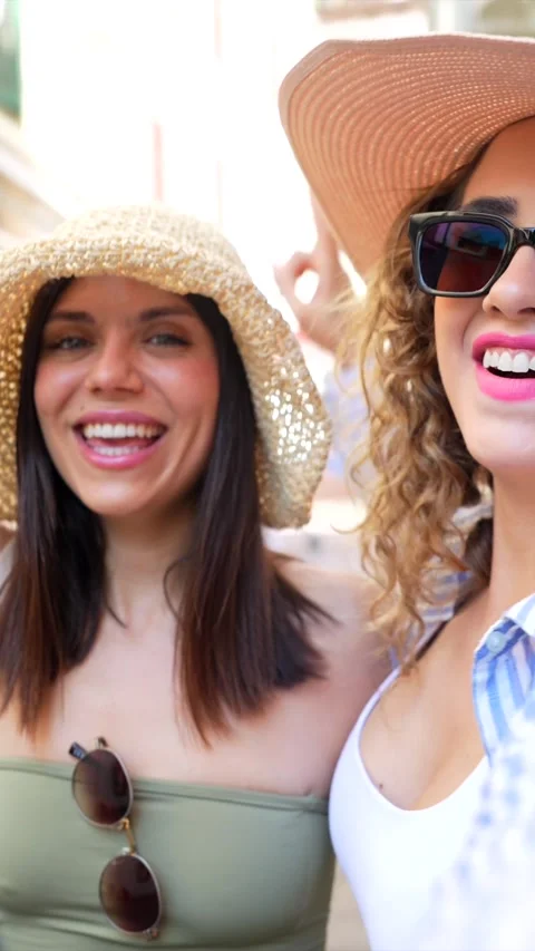Two happy tourists posing for a photo in a city center Stock Footage 311597580