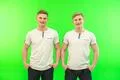 The two happy twin brother stand on the green background Photo