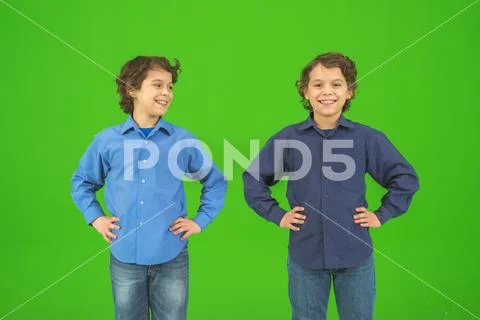 The two happy twin kids gesture on the green background Stock Photos