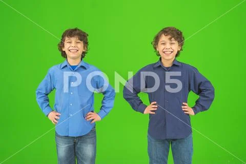 The two happy twin kids gesture on the green background Stock Photos