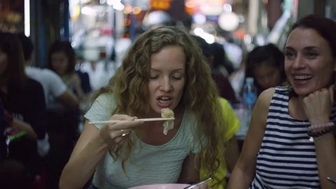 Two happy women talking while having soup in the restaurant 스톡 동영상 73241843