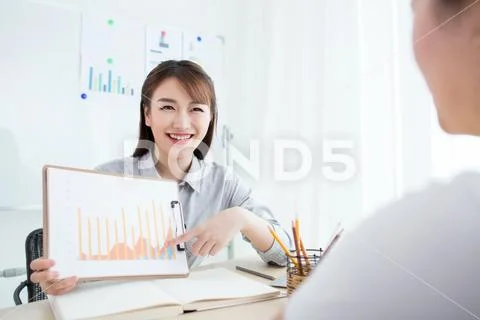 Two happy women working together in office Stock Photos