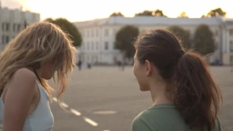 Two happy young girls hug each other. Females embracing, laughing and excited Stock Footage 219284853