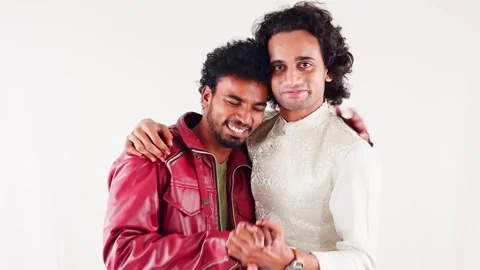 Two happy young man smiling celebrate success and laughing against a white .. Stock Footage 262934967