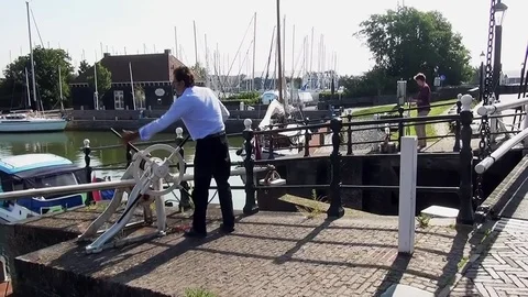 Two harbor master closing the sealock doors.doors of Hindeloopen Stock Footage 84932405