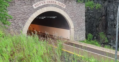 TWO HARBORS, MN - 18 JUN 2024: Vehicles exit a tunnel Stock Footage 288164325