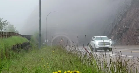 TWO HARBORS, MN - 18 JUN 2024: Vehicles on highway on rainy day Stock Footage 288164328