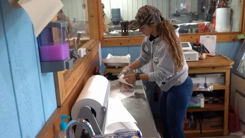 Two Harbors MN/USA August 1, 2019:Wrapping Fish fillets Stock Footage 125053121