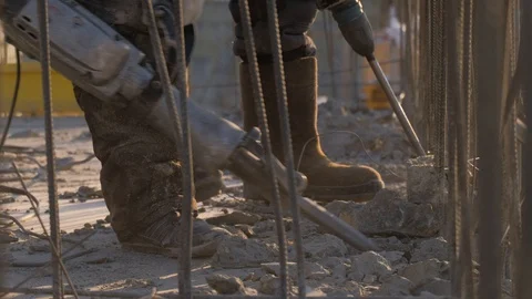 Two hard workers in professional equipment &amp; jackhammers destroy a concrete slab Stock Footage 129303239