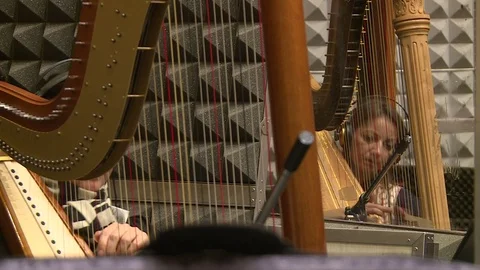 Two Harps Play Within an Symphonic Orchestra - Closeup Stock Footage 97730317