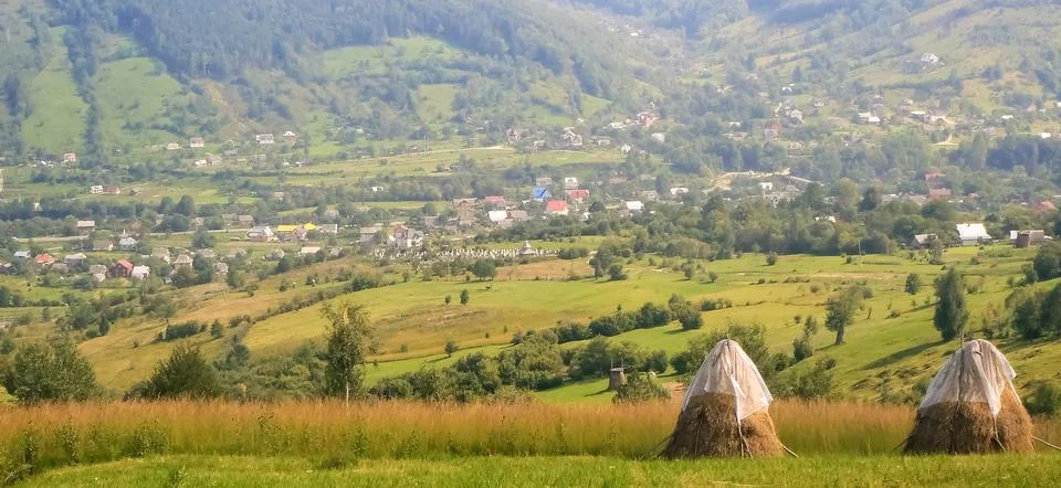 Two haystacks against the backdrop of fields Stock Photos