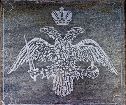 Two-headed eagle carved in stone. Stock Photos